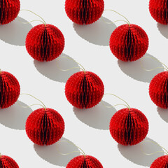 Top view of red honeycomb paper Christmas ornaments in minimal Seamless pattern on white. Bright...