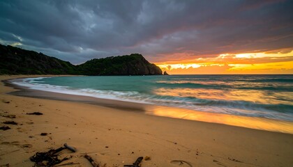 Dramatic sunset over Fernando de Noronha beach with dark clouds and golden light
