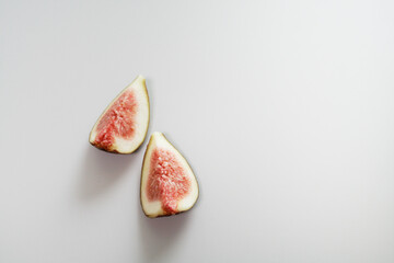 Two Sliced Figs on White Background