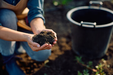 Close up of agronomist holding soil in her hands.