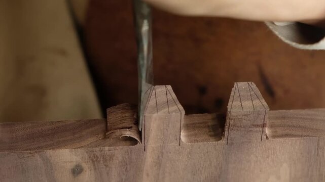Manual cutting of a dovetail joint using a chisel and mallet