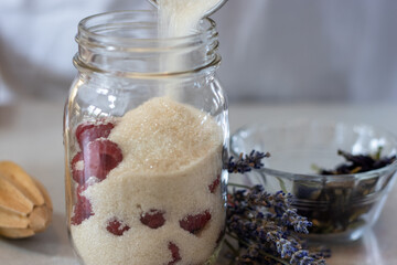 Raw Sugar Poured Over Fresh Raspberries in a Jar