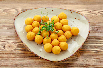 cheese balls on a plate with herbs