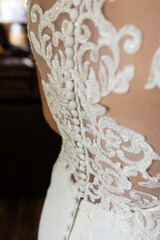 Intricate lace and button detailing on back of wedding gown.
