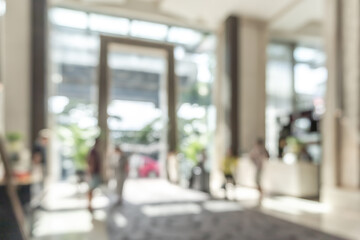 Hotel or office building lobby blur background interior view toward reception hall, modern luxury white room space with blurry corridor and building glass wall window