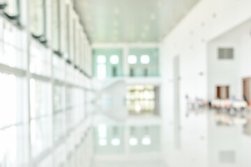 Office building blur background business lobby reception hall interior or empty indoor foyer meeting room with blurry light from glass wall window