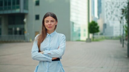 Elegant female professional in formal attire posing near a corporate business center symbolizing modern financial industry office work and business environment