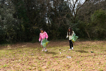 Volunteers collecting trash in forest: environmental cleanup activity