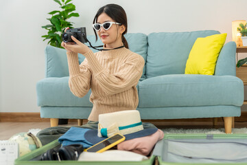 Traveler. preparing a camera for travel and photography. women are prepare clothes and personal...
