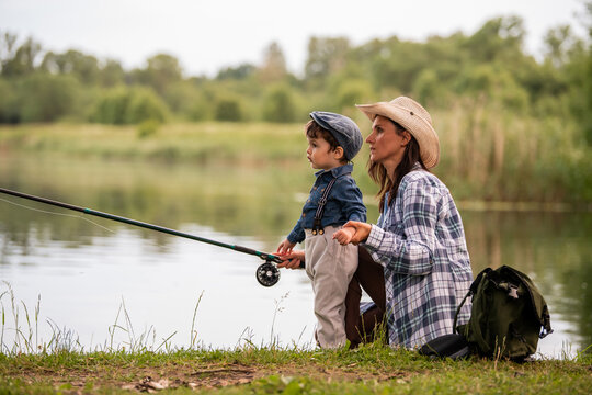 Toddler grandson and grandmother fishing on the lake