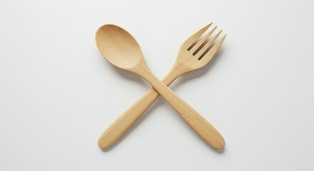 Rustic wooden spoon and fork create an inviting minimalist culinary composition against a bright