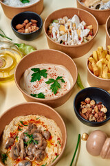 An Abundant Display of Delicious Middle Eastern Dishes Featuring Hummus, Nuts, and Tasty Appetizers in Natural Serving Bowls