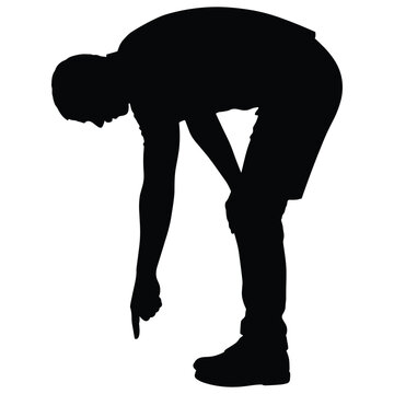 Man bending down pointing at the ground silhouette