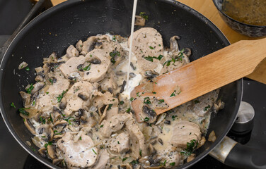 Pan-fried pork tenderloin in pieces in a creamy mushroom sauce