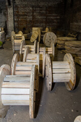 Empty wooden cable spool ready for wire or fiber optic storage. Industrial cable drum for...