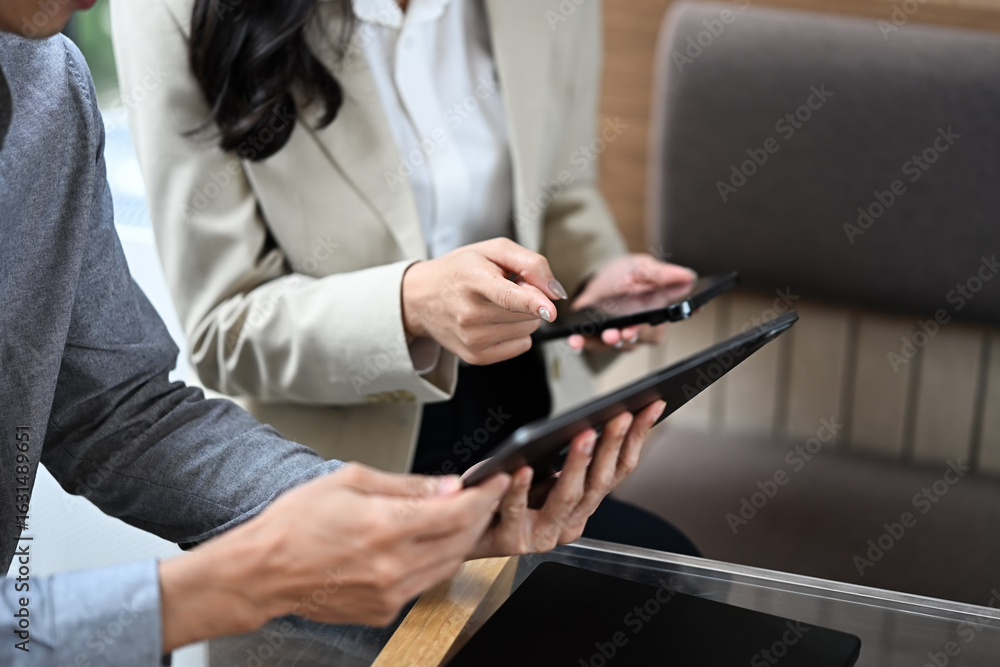 Poster hands of business partners discussing ideas while using digital tablets
