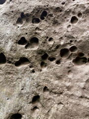 Texture and background of stones. Texture of rock. Natural dents in stones. Vertical background