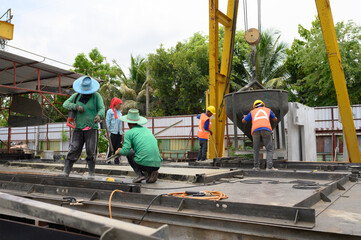 Workers are pouring cement and casting blocks to prepare for sale.