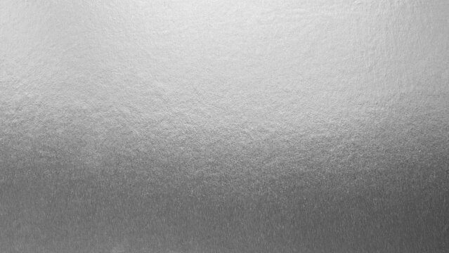 Silver background foil leaf metallic texture wrapping paper shiny glowing white grey solid reflective gradient color metal pattern backdrop for wallpaper decoration element backdrop