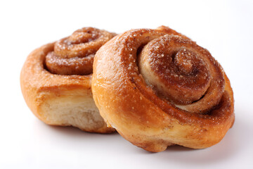 Fototapeta premium Cinnamon rolls arranged together on white background. Ideal for bakery menu, sweet food ads, or packaging visuals.