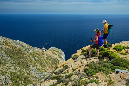 Hikers overlooking scenic coastal bay on Skyros Island in Greece - Powered by Adobe