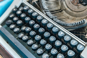 Vintage typewriter with a close-up on the keyboard. The keys are worn and dusty, suggesting years...