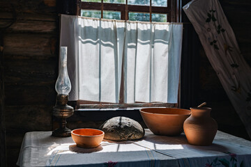 Rustic interior with a window bathed in sunlight. The room is dimly lit, but the window lets in a...