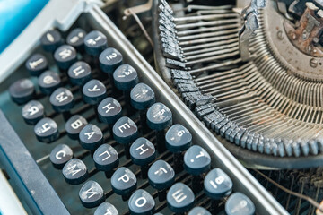 Vintage typewriter with a close-up on the keyboard. The keys are worn and dusty, suggesting years...