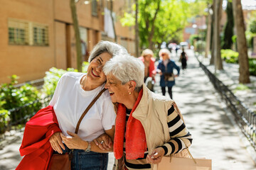 Senior woman strolling through the city with friends on a sunny day