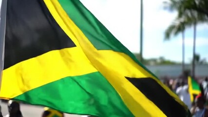 Jamaican Flag waving with sunny background Symbol of culture and pride in Jamaica.