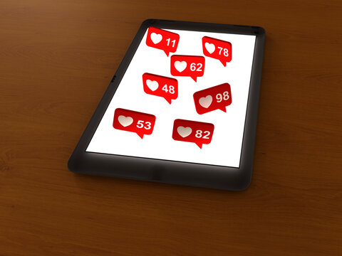 Tablet showing social media likes notifications on wooden table