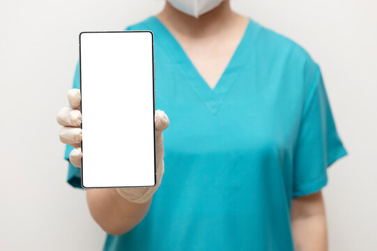 Nurse holding smartphone forward with screen visible
