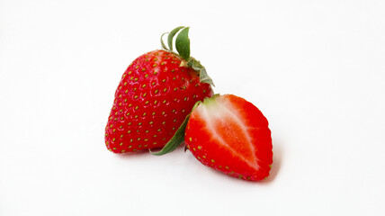 whole and half cut strawberries on white background. clipping path