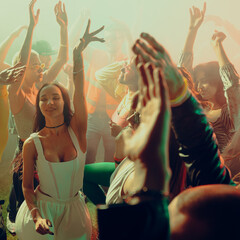 People dancing energetically at a lively party with colorful lighting. Concept of nightlife, party,...