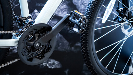 Crankset, chain and paddle with front wheel of modern bicycle in bike shop. Bicycle gear parts....