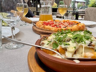 Pizza and wine on the table in a restaurant