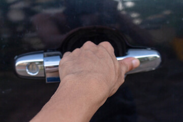Man's Hand Opening Green Car Door