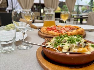Pizza and wine on the table in a restaurant