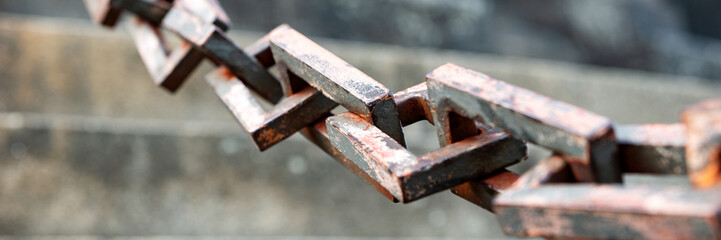 Panoramic image. Closeup of rusty rectangular chain links