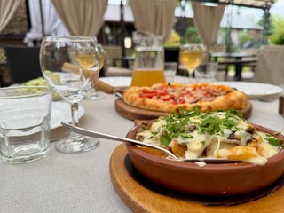 Pizza and wine on the table in a restaurant