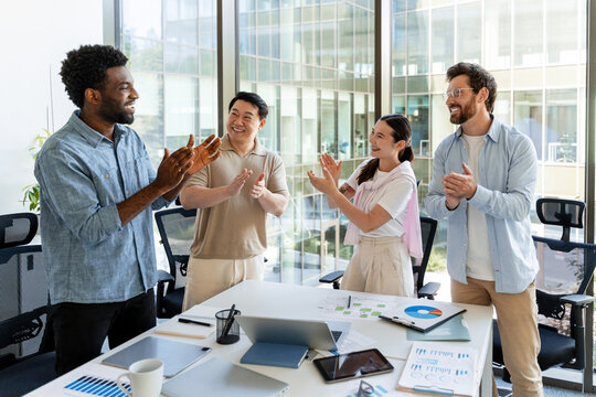 Happy business team applauding during a meeting in the office - Powered by Adobe