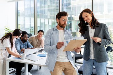 Business partners discussing marketing strategy during corporate meeting in modern office
