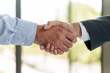 Business people shaking hands, making a deal