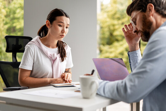 Stressed business people having a difficult conversation at work