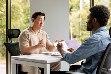 Managers discussing contract terms during business meeting
