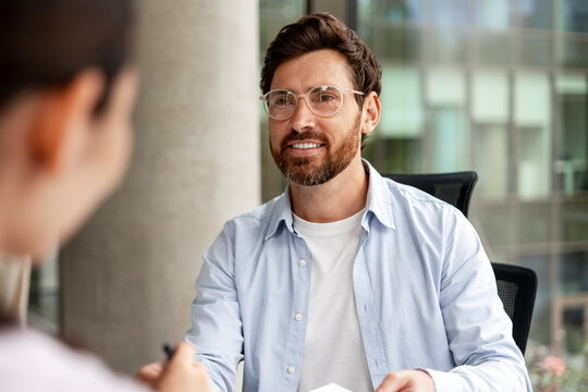 Businessman smiling during a job interview in a modern office