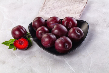 Raw ripe purple plum heap