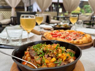 Pizza and wine on the table in a restaurant