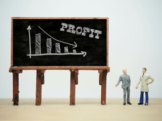 Mini toy of action figure at table with blurred background. Business financial photography concept...