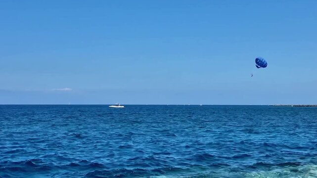 Experience an unforgettable thrill of parasailing high above stunning blue seas and vibrant, picturesque scenery